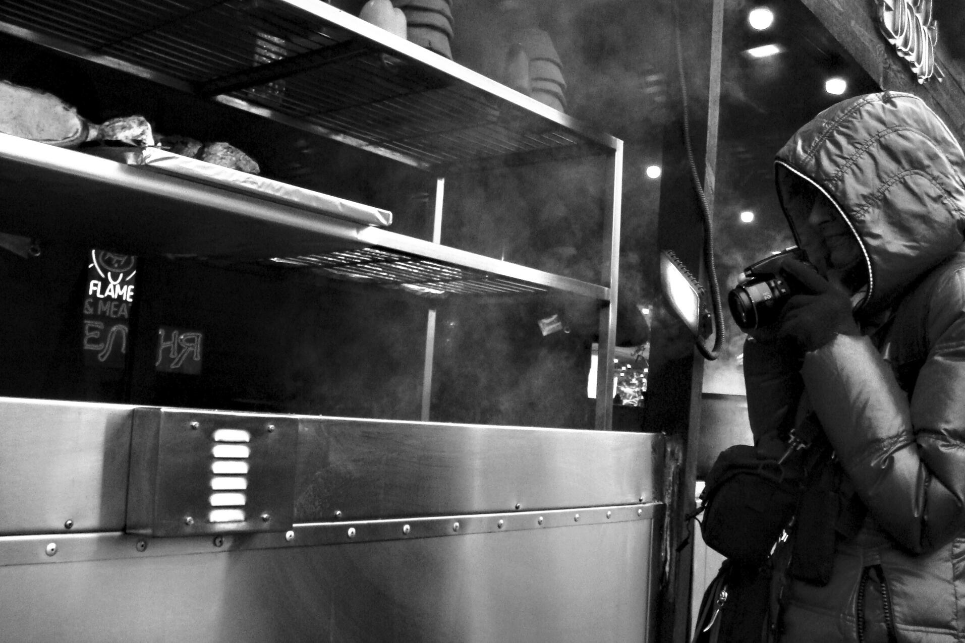 Photographer at a street fair. Kyiv, Ukraine, March 2025. Shot on Sony DSC-T100.